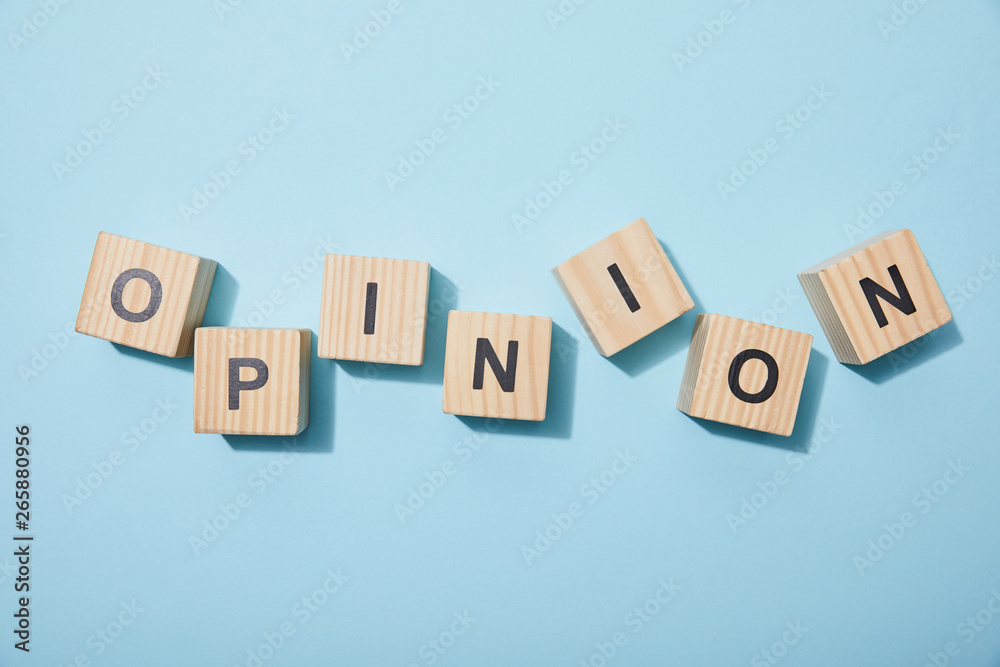 top view of wooden cubes with letters on blue surface top view of wooden cubes with letters on blue surface