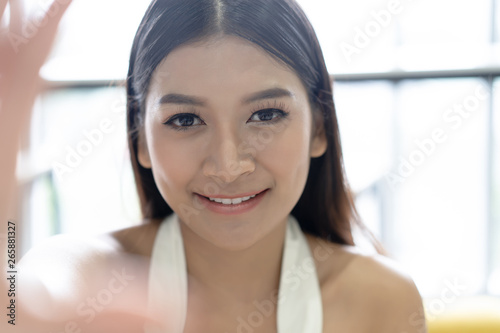Closeup Young Asian woman take selfie from hands with phone in her office. Concept business woman lifestyle happy.