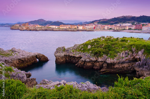 Spain, Cantabria, Castro-Urdiales, view of town and horseshoe cove at dusk photo