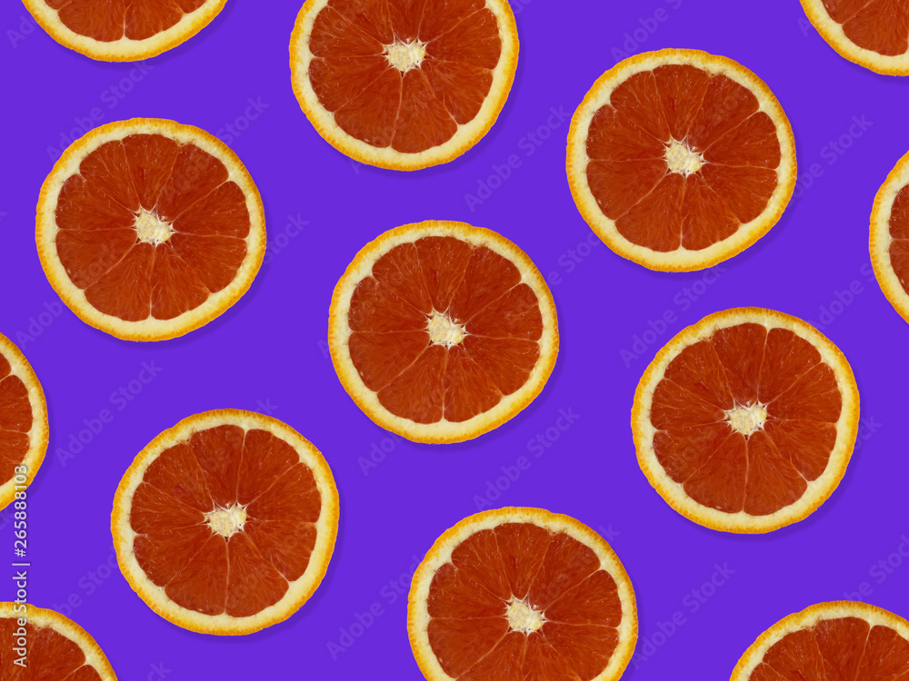 Creative pattern made of red oranges. top view of colorful fruit pattern of fresh red orange slices on purple colorful background. Creative pattern made of red oranges. top view of colorful fruit pattern of fresh red orange slices on purple colorful background.