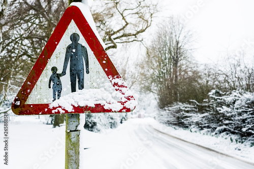 Close up of a 'Pedestrians in road' sign on side of snow-covered rural road.,Aston Rowant photo