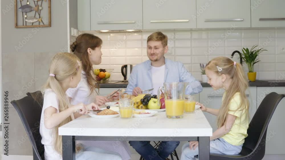 Happy family talking during breakfast Happy family talking during breakfast