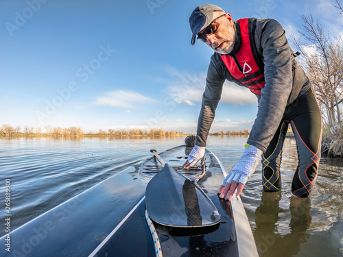 launching stand up paddleboard on lake