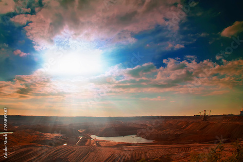 Industrial view of opencast mining quarry with machinery at work. Area has been mined for copper,silver, gold, and other minerals