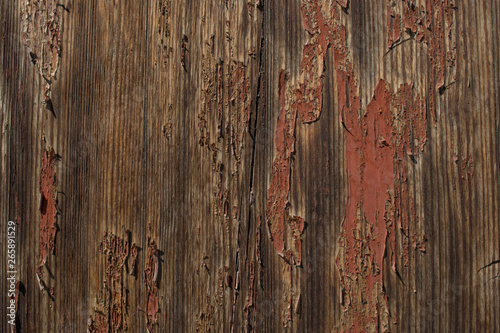 The wooden panel is covered with old peeling paint
