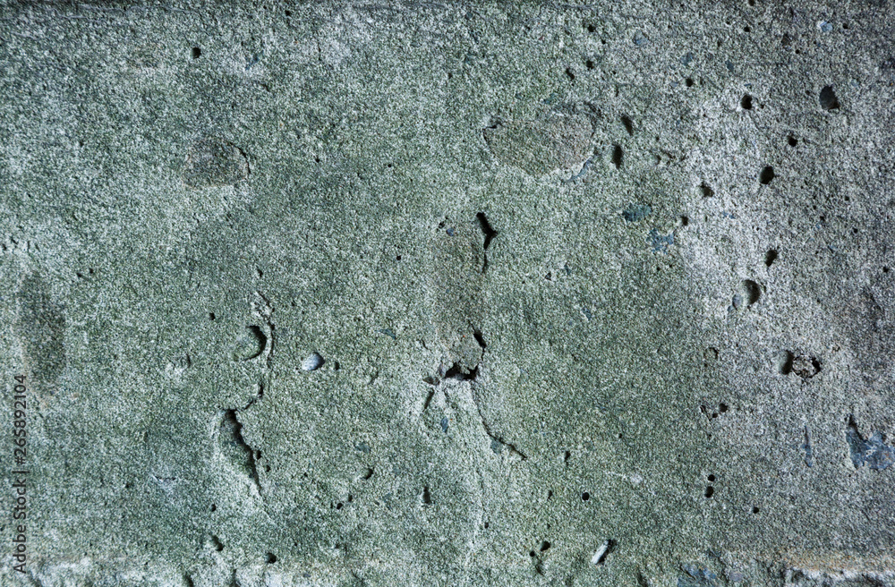 Grey and green abstract textured grunge wall background for use in design. Wall fragment with cracks, scratches Grey and green abstract textured grunge wall background for use in design. Wall fragment with cracks, scratches