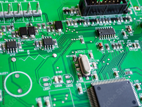 Fototapeta Naklejka Na Ścianę i Meble -  Close-up of printed electronic circuit board with processor and many integrated electrical components. Nanotechnology hardware system. Modern digital science concept. CPU welding or assembled on PCB.