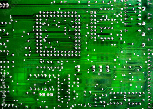 Close-up of printed electronic circuit board with processor and many integrated electrical components. Nanotechnology hardware system. Modern digital science concept. CPU welding or assembled on PCB.