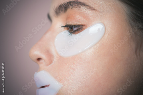 Moisturizing patches for eyes and lips. Taking care of her skin. Girl try eye patches. Daily pampering routine. Modern cosmetics. Eye patches concept. Reduce dark circles and puffiness. Skin moisture