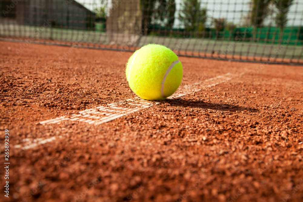 Tennis ball with racket on court 