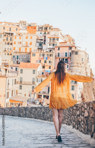 Tourist looking at scenic view of Manarola, Cinque Terre, Liguria, Italy