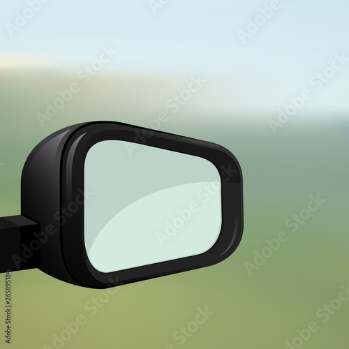 Car rearview mirror on a blurred background. 