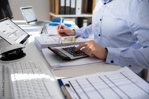 Businessperson Calculating Invoice