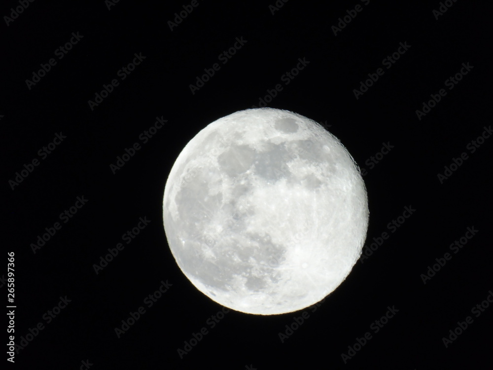 Genova, Italy - 03/22/2019: An amazing photography of the full moon over the city of Genova by night with a great clear sky in background and some stars Genova, Italy - 03/22/2019: An amazing photography of the full moon over the city of Genova by night with a great clear sky in background and some stars