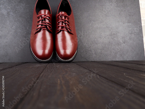 Stylish brown shoes for the groom, casual shoes on wooden background