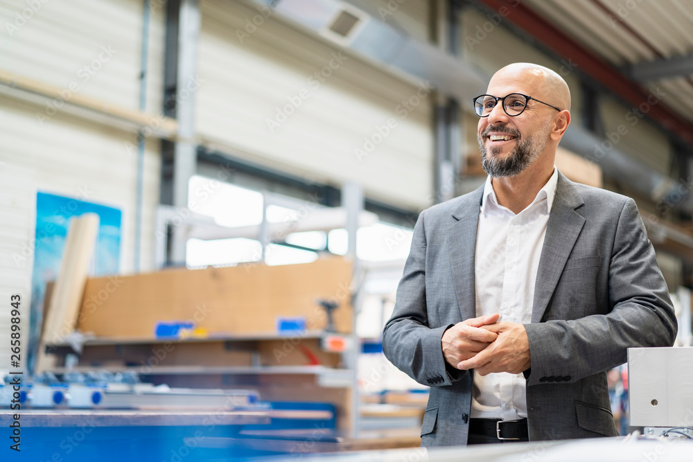 Happy businessman in factory Happy businessman in factory