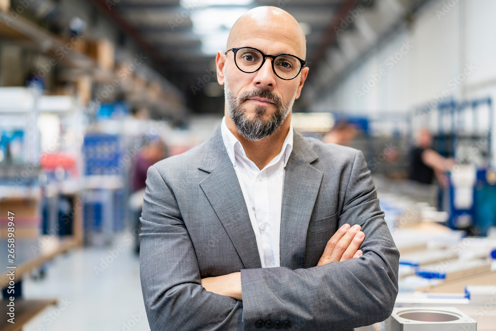 Portrait of confident businessman in factory Portrait of confident businessman in factory