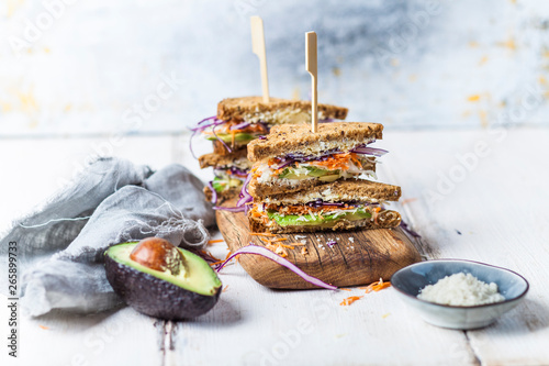 Veggie Sandwich, whole meal toast bread with grated carrot, red cabbage, white cabbage, avocado and cheese