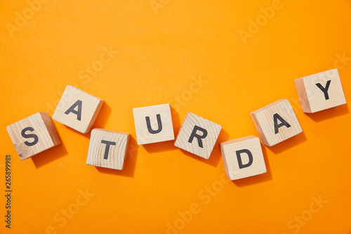 top view of wooden blocks with letters on orange surface