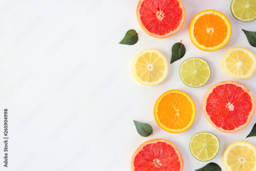 Colorful fruit frame of fresh citrus slices with leaves. Top view, flay lay over a white background with copy space. Colorful fruit frame of fresh citrus slices with leaves. Top view, flay lay over a white background with copy space.