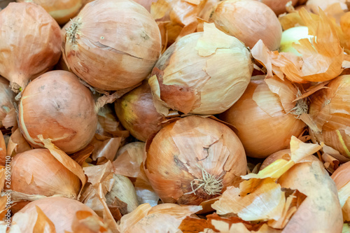 A pile of beautiful bulb onions on a counter photo