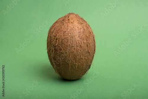 Coconut on green colored background.