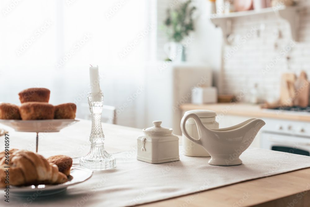 cakes and croissant on served table in kitchen