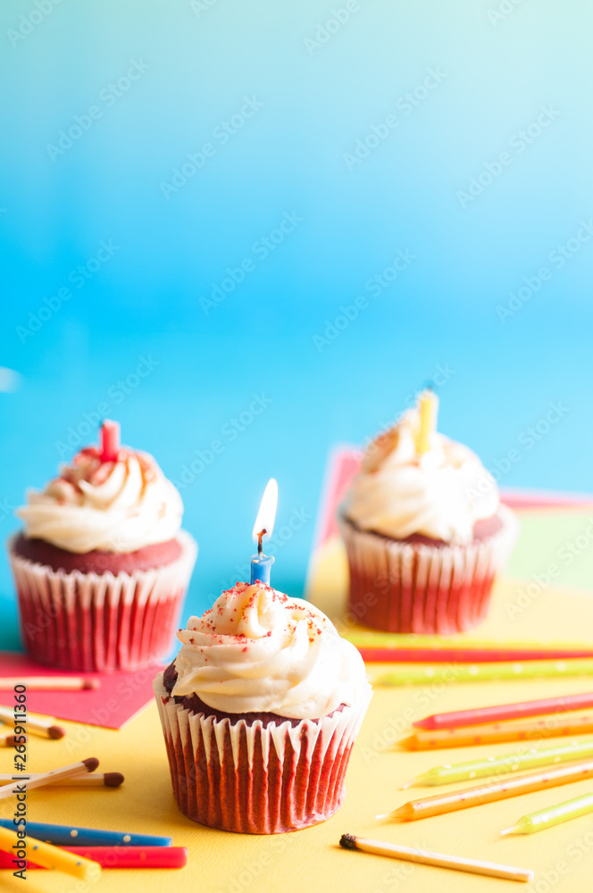 Birthday cupcake with candles and colorful background
