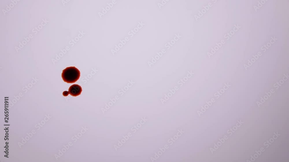 SINGLE DROP OF BLOOD FALLS DIRECTLY AT CAMERA.  FOLWED BY MORE DROPS.  SLOW MOTION AT 180 FPS.  NEGATIVE SPACE, NO PEOPLE