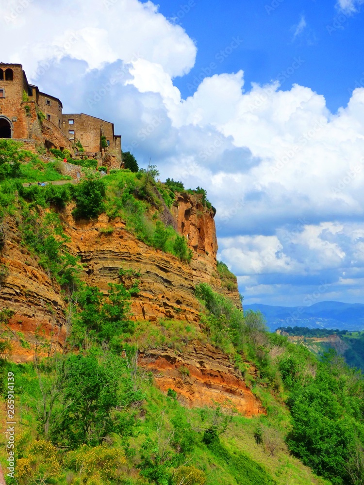 Stone cliff houses perched on a cliff in a hill town of Tuscany Italy.