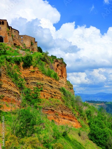 Stone cliff houses perched on a cliff in a hill town of Tuscany Italy.