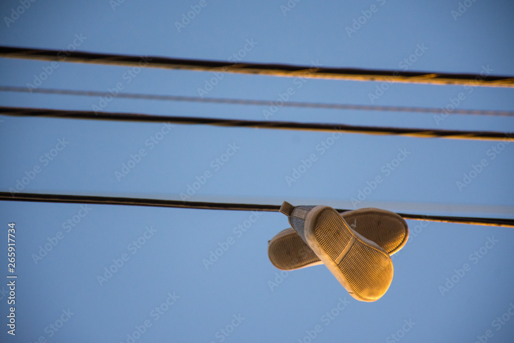 shoes hanging from a wire shoes hanging from a wire