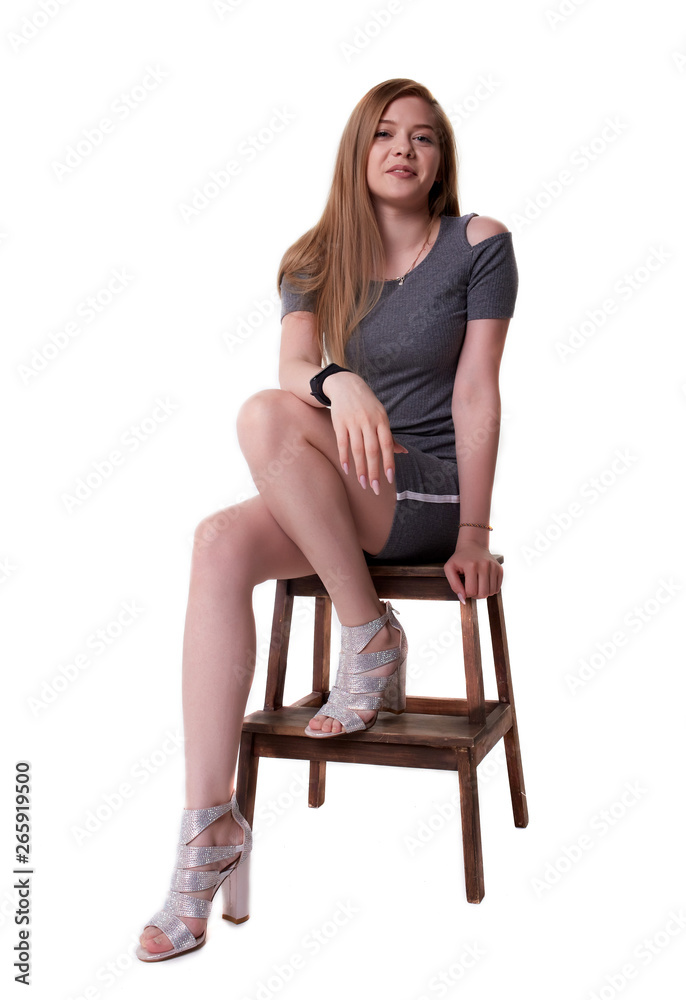Isolated on white background girl on a stool in a dress Isolated on white background girl on a stool in a dress
