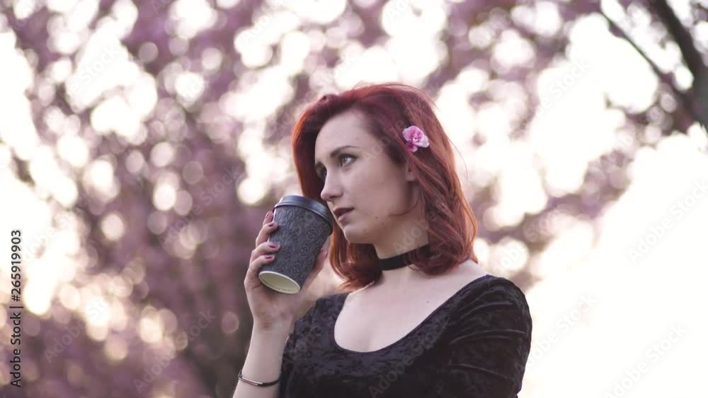 Portrait of Happy young travel dancer woman enjoying free time in a sakura cherry blossom park - Caucasian white redhead girl - Dressed black chocker, black dress and black golfs Portrait of Happy young travel dancer woman enjoying free time in a sakura cherry blossom park - Caucasian white redhead girl - Dressed black chocker, black dress and black golfs