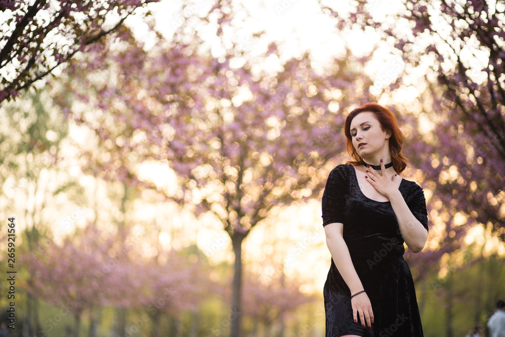 Happy young travel dancer woman enjoying free time in a sakura cherry blossom park - Caucasian white redhead girl - Dressed black chocker, black dress and black golfs Happy young travel dancer woman enjoying free time in a sakura cherry blossom park - Caucasian white redhead girl - Dressed black chocker, black dress and black golfs