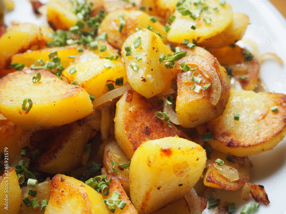 delicious crispy fried potatoes garnished with chive delicious crispy fried potatoes garnished with chive