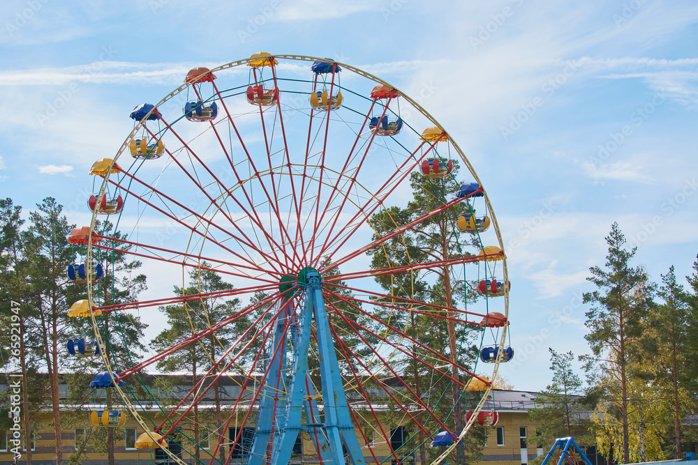 Childrens carousel ferris wheel for riding in amusement park.