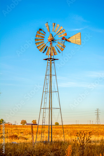 Classic Antique Rural Farm Windmill in a Field