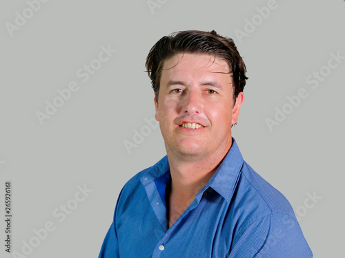 isolated portrait of young attractive and confident entrepreneur man in casual shirt smiling happy and positive looking at the camera in business success