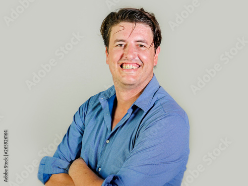 isolated portrait of young attractive and confident entrepreneur man in casual shirt smiling happy and positive looking at the camera in business success