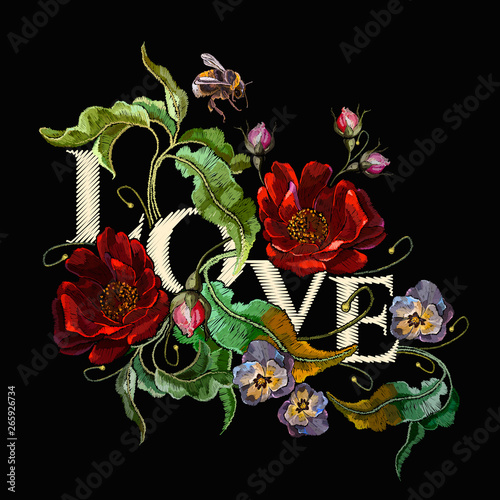 Love slogan. Embroidery blossoming red roses and violet flowers on black background. Template fashionable clothes, t-shirt design