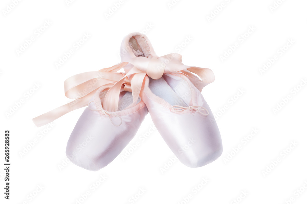 Pointe shoes ballet dance shoes with a bow of ribbons beautifully folded on a dark background. Pointe shoes ballet dance shoes with a bow of ribbons beautifully folded on a dark background.