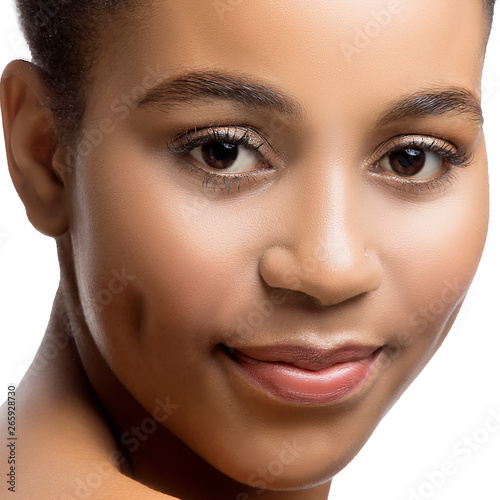 Close-up beauty face of young african woman with perfect skin, nude natural make-up