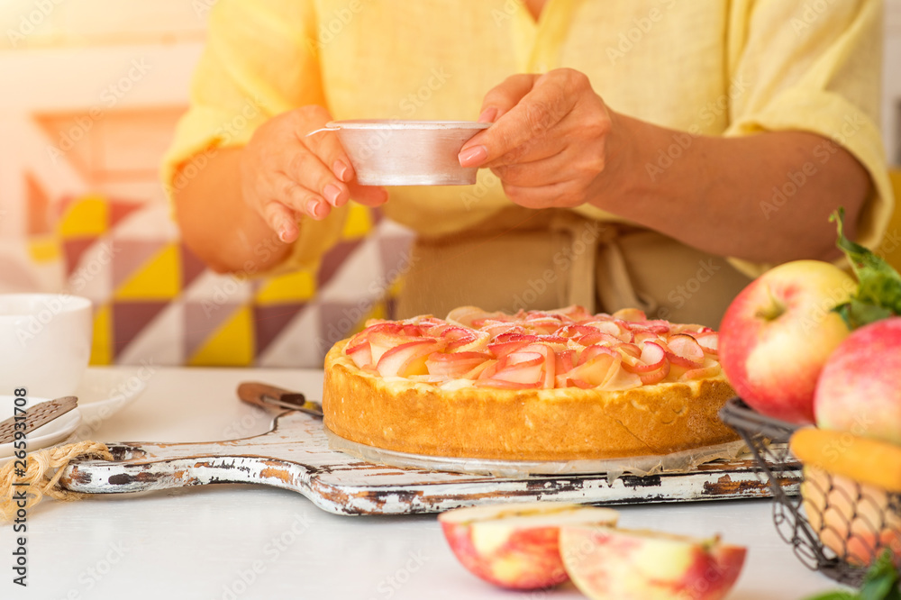 Woman make homemade apple pie. Confectioner make dessert. Apples on the table. Summer fruit dessert. Process of cooking apple pie, top view. Cooking and home concept.