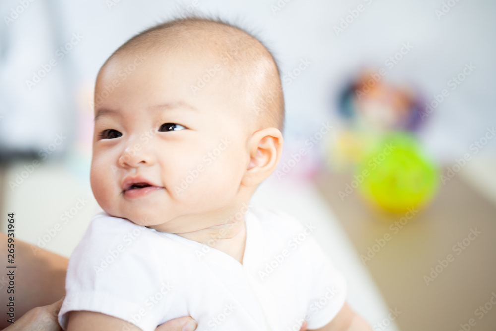 Asian baby happy in the room.Asian baby girl lying down on bed . Asian baby happy in the room.Asian baby girl lying down on bed .