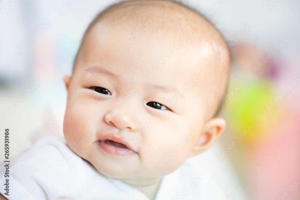Asian baby happy in the room.Asian baby girl lying down on bed . Asian baby happy in the room.Asian baby girl lying down on bed .