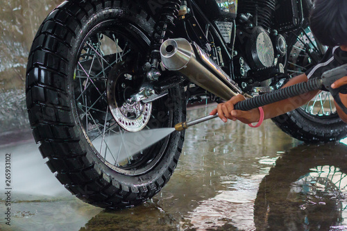 A man cleaning motorcycle 