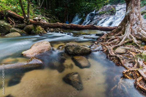 Long exposure shot.Waterfall with rocks in rainforest.
