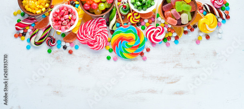 Colorful candies, jelly and marmalade on a white wooden background. Sweets. Top view. free copy space.