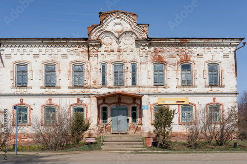 The old buildings built of a brick, destroyed by time and the nature at the beginning of spring in sunny day. Russian remote place.